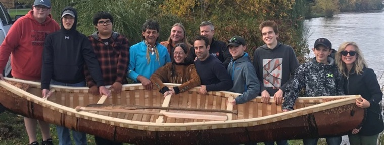 2018 recipient of the Ontario Arts Foundation Artist Educator Award, Chuck Commanda (fourth from left) with students from Smith Falls District Collegiate Institute, birch bark canoe workshop, 2018.