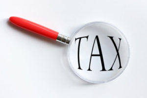 Magnifying glass on tax text